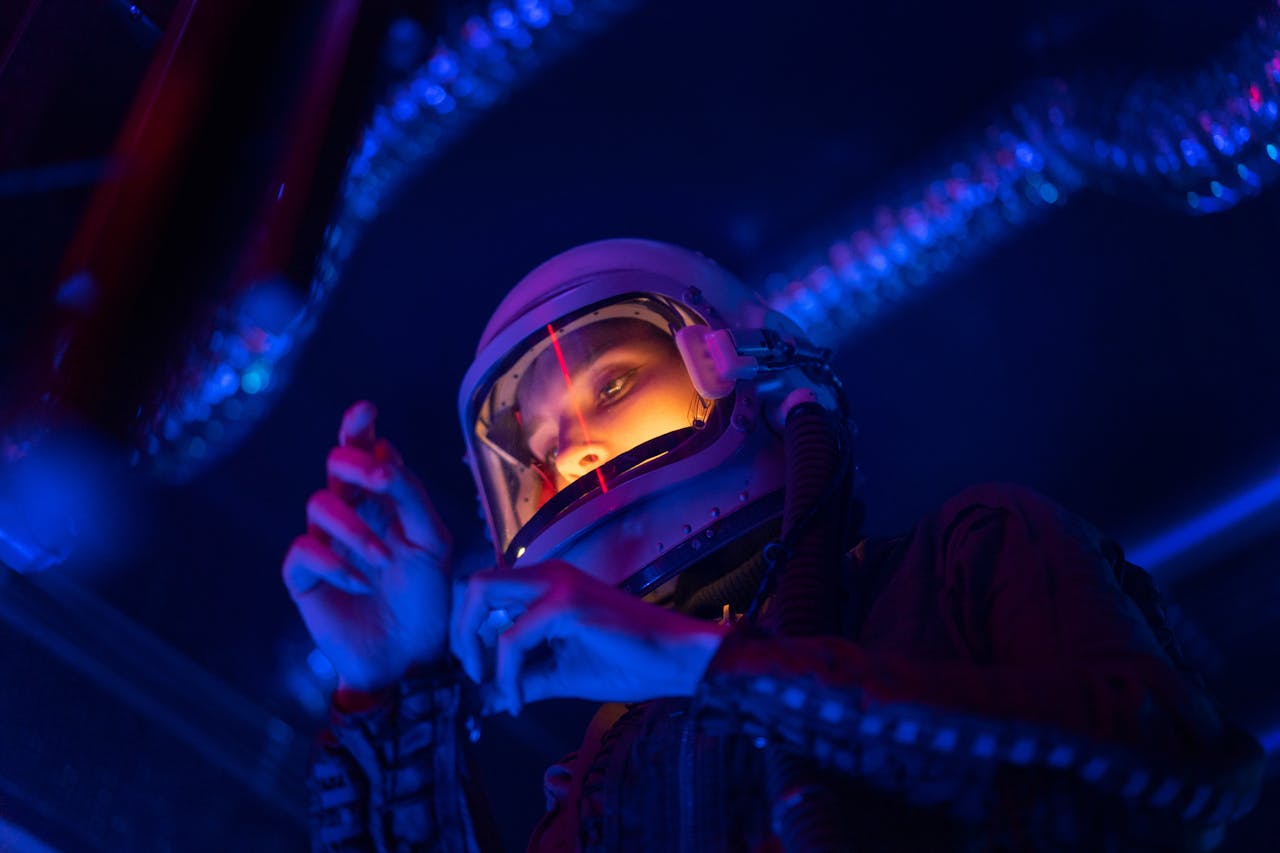 A spacewoman wearing a helmet, illuminated by futuristic neon lights, in an exploration setting.
